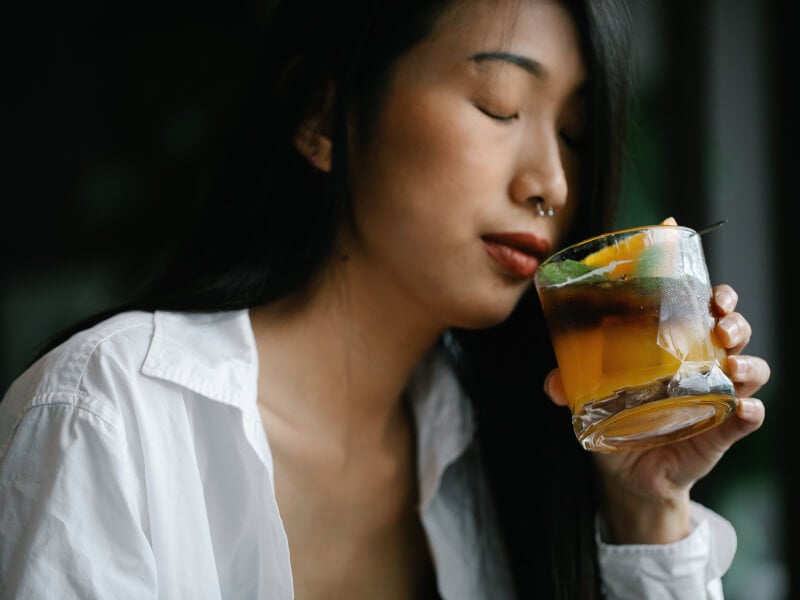 woman drinking cocktail at home